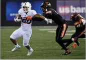  ?? STEVE DYKES — GETTY IMAGES ?? Stanford running back Austin Jones tries to get away from Oregon State defensive back Nahshon Wright during the second half last Saturday at Reser Stadium in Corvallis, Oregon.