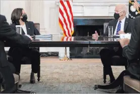  ?? Evan Vucci The Associated Press ?? President Joe Biden speaks with Vice President Kamala Harris about the southern border during a meeting Wednesday in the State Dining Room of the White House.