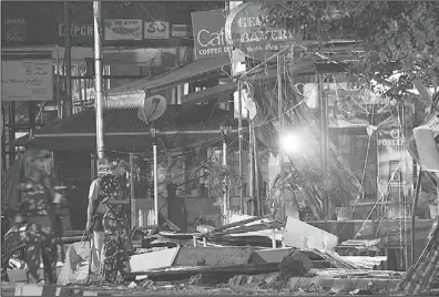  ??  ?? File photo shows Indian police inspecting the scene of an explosion outside a German bakery business close to the Osho Ashram in Pune, India. A court in India on April 15, convicted a man of murder for a bomb blast that killed 17 people three years ago...