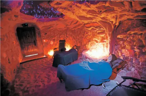  ?? PHOTOS BY LUIS SÁNCHEZ SATURNO/THE NEW MEXICAN ?? Julyne Gallegos of Santa Fe, back, and Ruby Thorne of Santa Fe relax last week at Santa Fe Salt Cave. The room’s walls and floor are covered with nine tons of pink salt mined in the Himalayas.