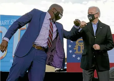  ?? AP ?? President-elect Joe Biden elbow bumps Senate candidate Raphael Warnock in Atlanta on Tuesday during a campaign rally for Warnock and Jon Ossoff. Warnock defeated Senator Kelly Loeffler in yesterday’s special election for an unexpired term for a US Senate seat in Georgia.