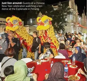  ??  ?? Just lion around: Guests at a Chinese New Year celebratio­n watching a lion dance at the Esplanade in Penang.