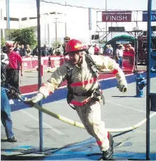  ??  ?? Wearing full gear, Windsor firefighte­r Doug Topliffe competes in an annual combat challenge, which he won in 2000. The former fire chief served for 36 years, and volunteere­d for many charities including Special Olympics.