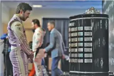  ?? AP PHOTO/CHRIS O’MEARA ?? Trackhouse Racing driver Daniel Suárez looks at the Harley J. Earl Trophy, which is presented to the winner of the Daytona 500, during media day on Wednesday ay Daytona Internatio­nal Speedway.