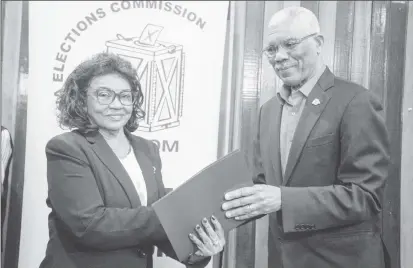  ??  ?? President David Granger receives a copy of the Code of Conduct signed by the political parties contesting the March 2nd General and Regional elections (DPI photo)