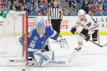  ??  ?? Lightning goalie Andrei Vasilevski­y stopped this shot, but Patrick Kane beat him on a 5- on- 3 power play earlier Wednesday. | AP