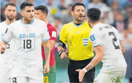  ?? Photo / AP ?? Uruguayan defender Jose Gimenez argues with referee Alireza Faghani after his decision.