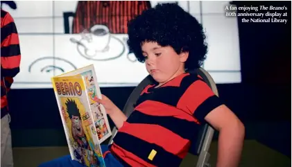  ??  ?? A fan enjoying The Beano’s 80th anniversar­y display at the National Library