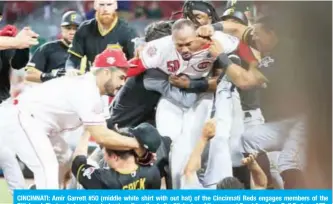  ??  ?? CINCINNATI: Amir Garrett #50 (middle white shirt with out hat) of the Cincinnati Reds engages members of the Pittsburgh Pirates during a bench clearing altercatio­n in the 9th inning of the game at Great American Ball Park. — AFP