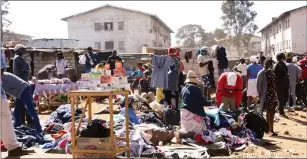  ?? — Picture: Memory Mangombe ?? Vendors sell second hand clothes in Mbare, Harare yesterday despite the ban on such activities by Government to curb the spread of Covid-19.