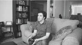  ?? Michael Ciaglo / Houston Chronicle ?? Joshua Zinn plays video games at his Galleria-area apartment. “I think if I had my choice, I would have lived alone from the start,” the 27-year-old said.