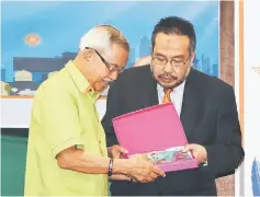  ??  ?? Mohd Radzif (right) presents a souvenir to Talib.