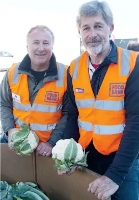  ??  ?? Volunteers Ed Semmens and Raymond Blake pick out fresh cauliflowe­r for families in need at Foodbank Victoria’s market in Warragul on Friday.