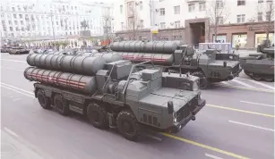  ?? (Tatyana Makeyeva/Reuters) ?? RUSSIAN SERVICEMEN sit in the cabins of S-400 missile air defense systems in central Moscow, in April.