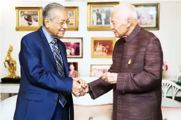  ??  ?? Dr Mahathir greets Prem during the courtesy visit at the latter’s residence yesterday. — Bernama photo