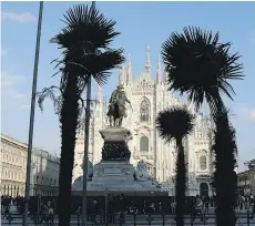 ?? THE ASSOCIATED PRESS ?? Palm trees sponsored by Starbucks are planted in flower beds in front of Milan’s Duomo Cathedral.