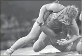  ?? Canadian Press photo ?? Canada's Erica Wiebe, top, wrestles with Nigeria’s Blessing Onyebuchi to win gold in women's FS 76Kg wrestling at the Commonweal­th Games on Gold Coast, Australia, Thursday.