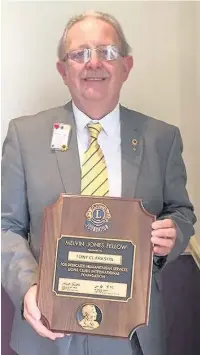  ??  ?? Hyndburn Centennial Lions Club president Tony Clarkson with the Melvin Jones Fellowship award in honour of his 32 years of service.