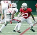  ?? PAUL VERNON — THE ASSOCIATED PRESS ?? Ohio State wide receiver De’Shawn White, right, tries to get past teammate safety Amir Riep during NCAA college football practice in Columbus, Ohio, Saturday.