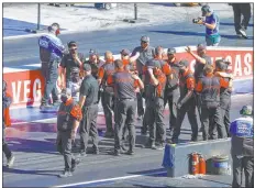  ?? Chase Stevens ?? Crew members rejoice after Steve Torrence’s Top Fuel victory Sunday at The Strip at Las Vegas Motor Speedway.