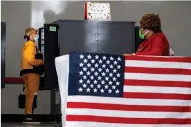  ?? Photograph: Ben Gray/AP ?? A voter casts a ballot on the first day of early voting in Atlanta on 17 October 2022.