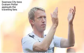  ??  ?? Swansea City boss Graham Potter applauds the travelling fans