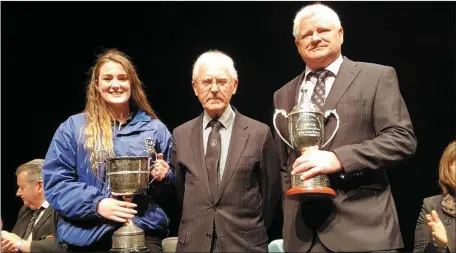  ??  ?? Drogheda Brass Band Musical Director Michael Maher (right) and young cornet player Grace Campbell accept the trophies from adjudicato­r Archie Hutchison after winning first prize in the National Band Championsh­ips at the Solstice Centre, Navan, on Sunday.
