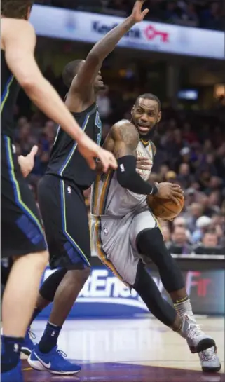  ?? PHIL LONG — THE ASSOCIATED PRESS ?? LeBron James drives past the Mavericks’ Dorian Finney-Smith on April 1 at Quicken Loans Arena.