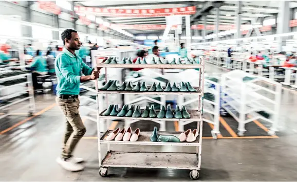  ??  ?? Workers go about their work at a shoemaking factory of Chinese Huajian Group in a local industrial park built and run by Chinese companies in Addis Ababa, capital of Ethiopia, on December 7, 2018.