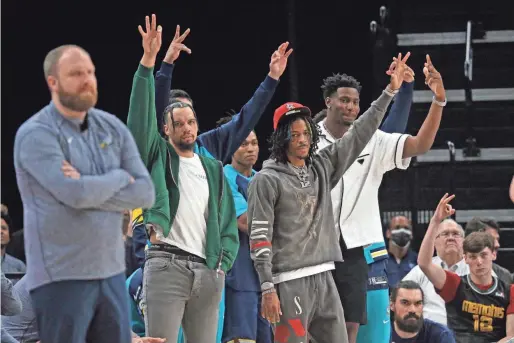  ?? PETRE THOMAS/USA TODAY SPORTS ?? Memphis Grizzlies guard Dillon Brooks (left), guard Ja Morant (middle) and forward Jaren Jackson Jr. react from the bench after a three-point basket against the Boston Celtics at Fedexforum.