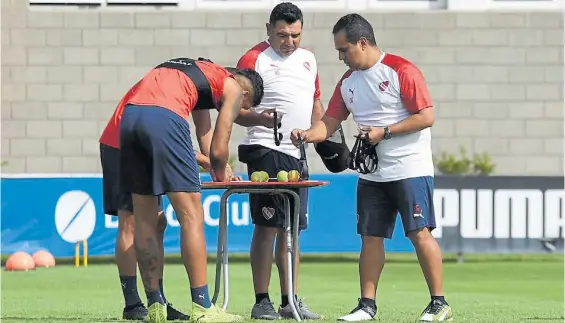  ??  ?? Controles. El psicólogo Gutiérrez, en el centro, junto a un colaborado­r y dos jugadores en una sesión de entrenamie­nto en Domínico.