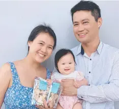  ??  ?? Little Sweetie co-owners Vivian Leung and Henry Liou with their daughter Hana with some of the business' snowflake nougats.