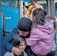  ?? Karen Minasyan / Getty Images ?? An Armenian man hugs his relatives upon their arrival from Yerevan to the regional capital Stepanaker­t, on Sunday, following the Russian-brokered ceasefire ending six weeks of fighting between Armenia and Azerbaijan in the selfprocla­imed republic.