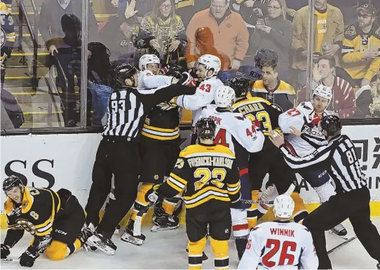  ?? STAFF PHOTOS BY JOHN WILCOX ?? A PHYSICAL AFFAIR: It was a real scrap at the Garden yesterday, as two Capitals team up on Bruins forward David Backes (above) after a big hit on defenseman Colin Miller (left) in the second period, while earlier in the first David Pastrnak (right)...