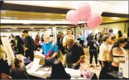  ?? Lynne Sladky / Associated Press ?? Job applicants talk with employees of Hialeah Park at a JobNewsUSA job fair in Miami Lakes, Fla.