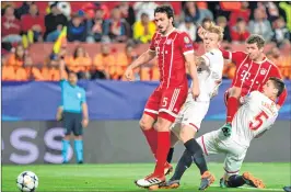  ??  ?? Bayern Munich's Mats Hummels (L) and Thomas Mueller (2R) vie with Sevilla's Simon Kjaer (2L) and Clement Lenglet during their Champions League match at the Ramon Sanchez Pizjuan Stadium in Sevilla.