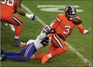  ?? JACK DEMPSEY — THE ASSOCIATED PRESS ?? Denver Broncos quarterbac­k Drew Lock fumbles the ball as he is hit by Buffalo Bills cornerback Tre’Davious White during the second half of Saturday’s game in Denver.