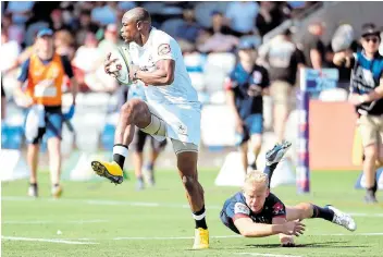  ?? WILLIAM WEST Picture: AFP/ ?? TRY HERO: Makazole Mapimpi evades the tackles of Rebels player Andrew Deegan en route to scoring one of Saturday's two tries.