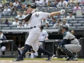 ?? BILL KOSTROUN — THE ASSOCIATED PRESS ?? New York Yankees’ Aaron Judge hits a two-run home run as Seattle Mariners catcher Mike Zunino, right, looks on during the first inning of a baseball game Thursday at Yankee Stadium in New York.
