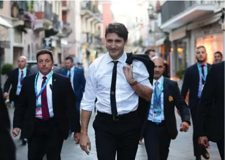  ?? SEAN KILPATRICK/THE CANADIAN PRESS ?? Prime Minister Justin Trudeau walks through the seaside resort town of Taormina, Italy, as he attends the G7 Summit on Friday.