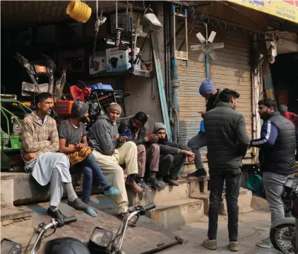  ?? ?? Shopkeeper­s and workers wait for electric power at a market following a power breakdown across the country, in Lahore, Pakistan, Monday, January 23, 2023. Photo: AP/K.M. Chaudary.