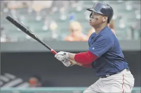  ?? Gail Burton / Associated Press ?? the red Sox’s rafael devers follows through on a go-ahead leadoff homer in the 10th inning against the orioles on Sunday in Baltimore. it was Boston’s fifth straight victory to move a season-high five games over .500 after a 9-15 start.