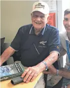  ?? MEG JONES / MILWAUKEE JOURNAL SENTINEL ?? Clarence “Bud” Anderson, 97, signs copies of his book at EAA AirVenture in Oshkosh.