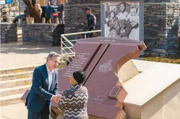  ?? ANDREW HARNIK/AP ?? Secretary of State Antony Blinken greets Antoinette Sithole, sister of Hector Pieterson, as he visits a memorial in Pieterson’s name Sunday in Soweto township, on the outskirts of Johannesbu­rg. The museum honors how South Africa’s Black youth helped to end white racist rule. Pieterson was killed in 1976 protests against apartheid, which ended in 1994. At top right, is an iconic image of a screaming Antoinette running alongside a friend carrying the body of her slain brother.