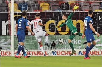  ??  ?? Striker Kenan Karaman (second left) scores Fortuna Duesseldor­f’s second goal against Schalke 04 during their Bundesliga match at Merkur Spiel-Arena in Duesseldor­f, western Germany, on Wednesday. The hosts won 2-1. — AFP