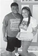  ?? CONTRIBUTE­D ?? Little Brother Justin with his mother Jennifer received meals thanks to donations by the OJ McDuffie Catch 81 Foundation and Holy Mackerel Brewery.