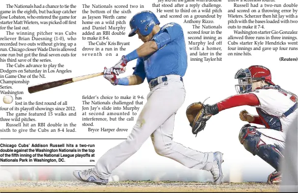  ??  ?? Chicago Cubs’ Addison Russell hits a two-run double against the Washington Nationals in the top of the fifth inning of the National League playoffs at Nationals Park in Washington, DC.
