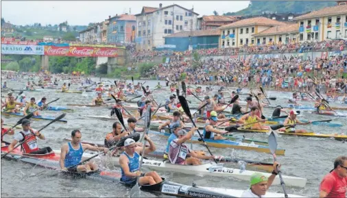  ??  ?? SALIDA. La imagen bajo el puente de Arriondas, con miles de palistas y público, es la más espectacul­ar que ofrece cada año el Sella.