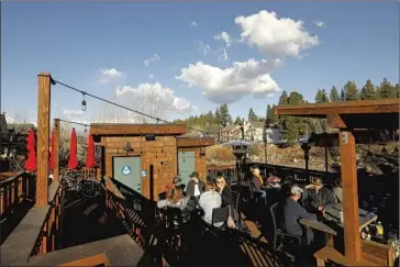  ?? Carolyn Cole Los Angeles Times ?? PEOPLE dine outdoors in downtown Truckee, Calif. The deluge of remote workers since the pandemic began is hard to miss in the town of 16,000. Locals complain about increased traffic on the streets and the ski slopes.