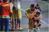  ??  ?? Ringling Bros boss clown Sandor Eke hugs his 2-year-old son Michael after the red unit's final show.